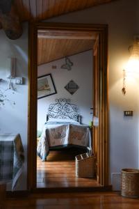 a bedroom with a bed and a door open at B&B Va...lentina in Piavata