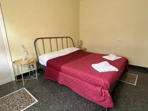 a bedroom with a bed with a red blanket at LIGURIA HOLIDAYS - "La Casa di Gisella" in Camogli