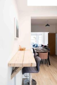a dining room with a wooden table and chairs at Charming 3 bedroom Belfast townhouse in Belfast