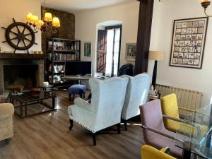a living room with blue chairs and a fireplace at La Casona de Barganaz in Ranón