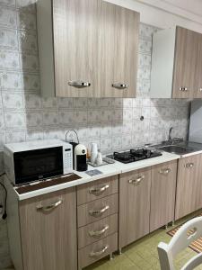 a kitchen with a microwave and a stove in it at Filippo Accomodation in Tropea