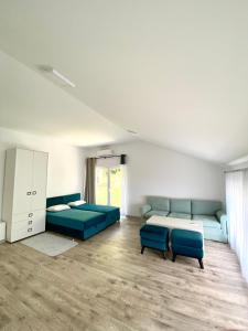 una grande camera con due letti e divani blu di Orachovac apartments a Kotor (Cattaro)