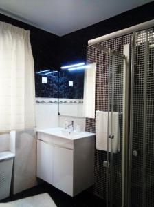 a bathroom with a sink and a shower at Chalas place in Nazaré +31 photos