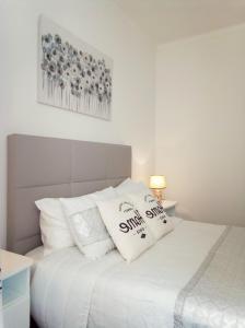a bedroom with a bed with two pillows on it at Chalas place in Nazaré