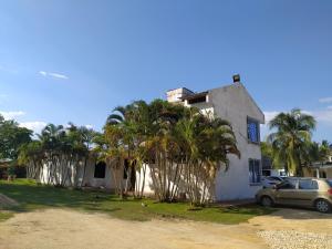 a house with palm trees in front of it at COVEÑAS ECOREAL in Coveñas