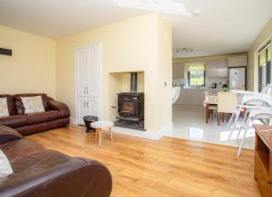 a living room with a couch and a stove at Lakeview Waterville Holiday Home in Waterville