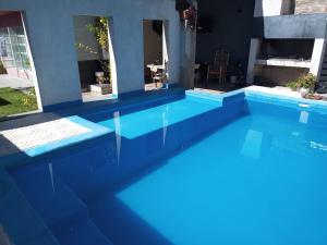 a pool with blue water in front of a house at ND nuestro destino in Cafayate