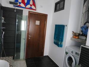 a bathroom with a shower and a washing machine at Apartment Haifa in Haifa +21 photos