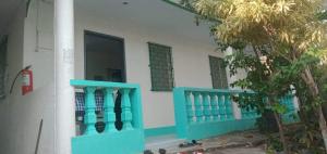 a house with blue and white walls and windows at Pescador View Extension near the Ocean in Moalboal