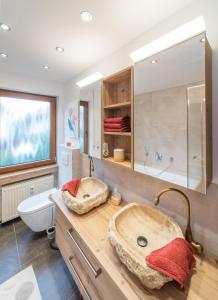 a bathroom with a large sink and a toilet at BCA Family Apartments Herzo Süd in Herzogenaurach