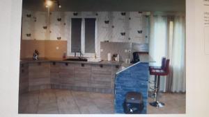 a kitchen with a sink and a counter top at Maison chez DANETTE in Thilay