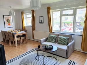 a living room with a couch and a table at Amber House Leisure & Contractors in Worting