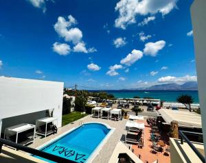 a resort with a swimming pool and a view of the ocean at Faedra Beach in Agios Nikolaos