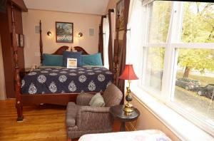 a bedroom with a bed and a chair and a window at Ray's Bucktown Bed and Breakfast in Chicago