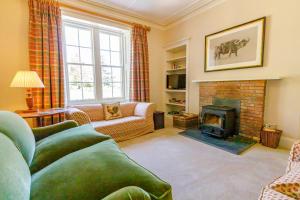 a living room with a couch and a fireplace at Dalgheal in Evanton