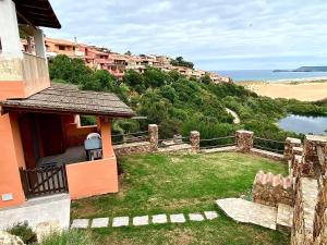 a house with a yard with a view of the ocean at Torre dei Corsari APPARTAMENTO CON GIARDINO VISTA MARE in Torre Dei Corsari +2 photos