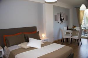 a bedroom with a bed and a dining room with a table at Appartamento Mare Marconi in Letojanni