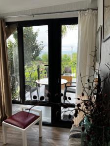 a living room with a door open to a patio at Artist's Cellar in Tʼelavi