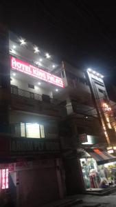 a building with a neon sign on it at night at Hotel king palace in Chandīgarh