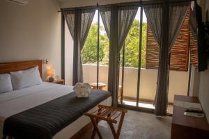 Postel nebo postele na pokoji v ubytování Hotel Muyu Tulum + 37 fotografií