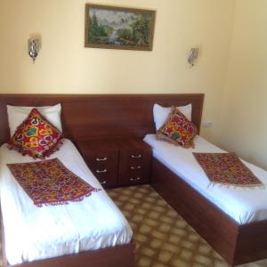 Un ou plusieurs lits dans un hébergement de l'établissement Samarkand Dream Hotel