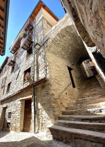 a stone building with stairs in front of it at Romantic home with beautiful view lake of Como and Villa Oleandra in Laglio