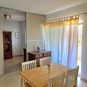 a dining room with a table and chairs and a dresser at Apartmani Val in Pula