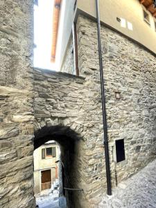 a stone building with a tunnel in the side of it at Romantic home with beautiful view lake of Como and Villa Oleandra in Laglio