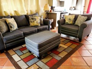 a living room with a couch and two chairs at The Cottage at Villa Indigo in Charlotte Amalie +27 photos