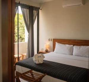 Postel nebo postele na pokoji v ubytování Hotel Muyu Tulum