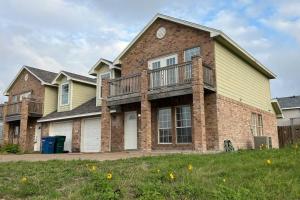 a large brick house with a porch and a balcony at Waterview Townhouse 4-Bedrooms in Corpus Christi
