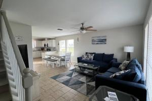 a living room with a blue couch and a table at Waterview Townhouse 4-Bedrooms in Corpus Christi