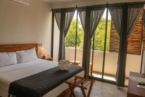 Postel nebo postele na pokoji v ubytování Hotel Muyu Tulum