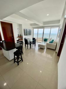 sala de estar con mesa de comedor y sala de estar con vistas al océano. en 2P1-AL3 APARTAMENTO DE 2 ALCOBAS FRENTE AL MAR CON AIRE ACONDICIONADO Y WIFI, en Cartagena de Indias