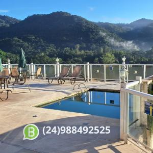 a swimming pool on the roof of a house at Pousada Terraço Penedo in Penedo