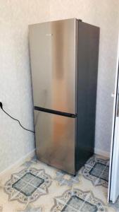 a stainless steel refrigerator in the corner of a room at sweet home in Sevan