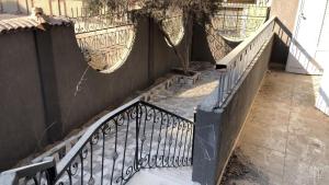 a set of stairs with a wrought iron railing at احجزلى in 6th Of October