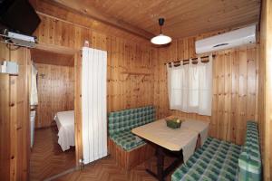 a dining room with a table and two chairs at Il Frantoio Camping in San Bartolomeo al Mare