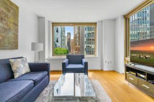 a living room with a couch and a tv at Global Luxury Suites at The Marc in New York