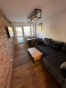 a living room with a couch and a table at Apartament Centroom in Olsztyn