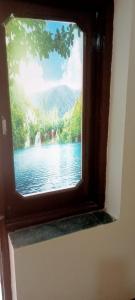 a window with a view of a lake in a room at Hotel king palace in Chandīgarh