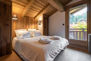 a bedroom with a bed with two towels on it at Chalet Isatis in Megève
