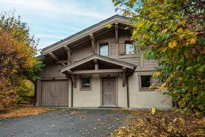 a house with a garage and a driveway at Chalet Isatis in Megève