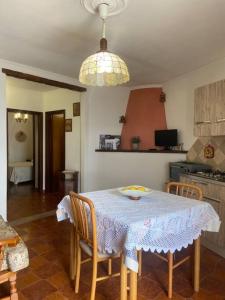 a kitchen with a table and chairs with a table and a dining room at Su Murcone Appartamento Baunei in Baunei