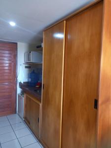 uma cozinha com armários de madeira e uma bancada em Maria Leuça Teixeira Duarte em Natal
