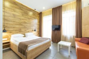 a bedroom with a large bed and a couch at Downtown River Apartments in Tbilisi City