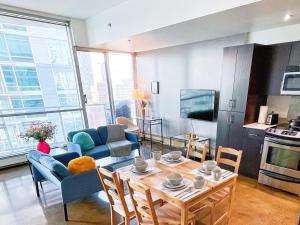 a kitchen and living room with a table and chairs at 2BR condo in downtown, w/ view+parking in Calgary