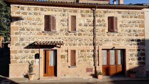 a large stone building with two doors and windows at L’ANGOLETTO in San Lorenzo Nuovo