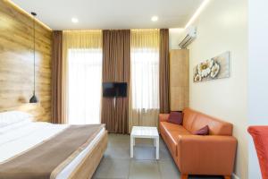 a bedroom with a bed and a couch at Downtown River Apartments in Tbilisi City