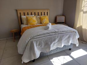 een slaapkamer met een bed met handdoeken erop bij Grassland 4 (Townhouse) in Bloemfontein